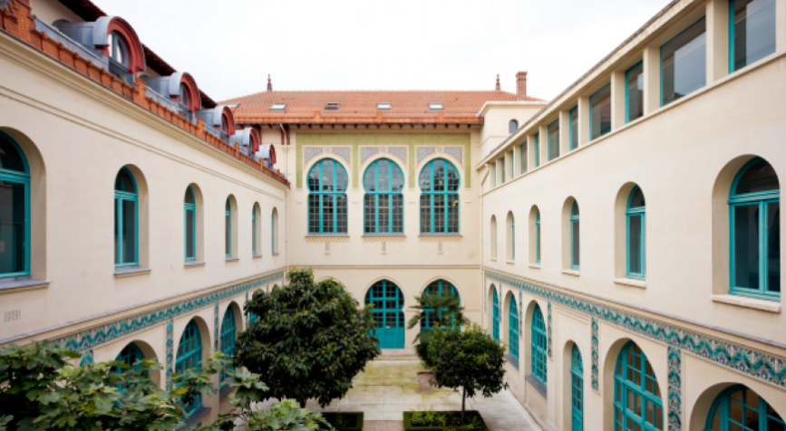 Photo of a white villa with green windows